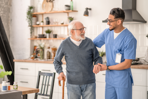 Life Assure Medical Worker Helping His Patient Move Around Apartment Blog